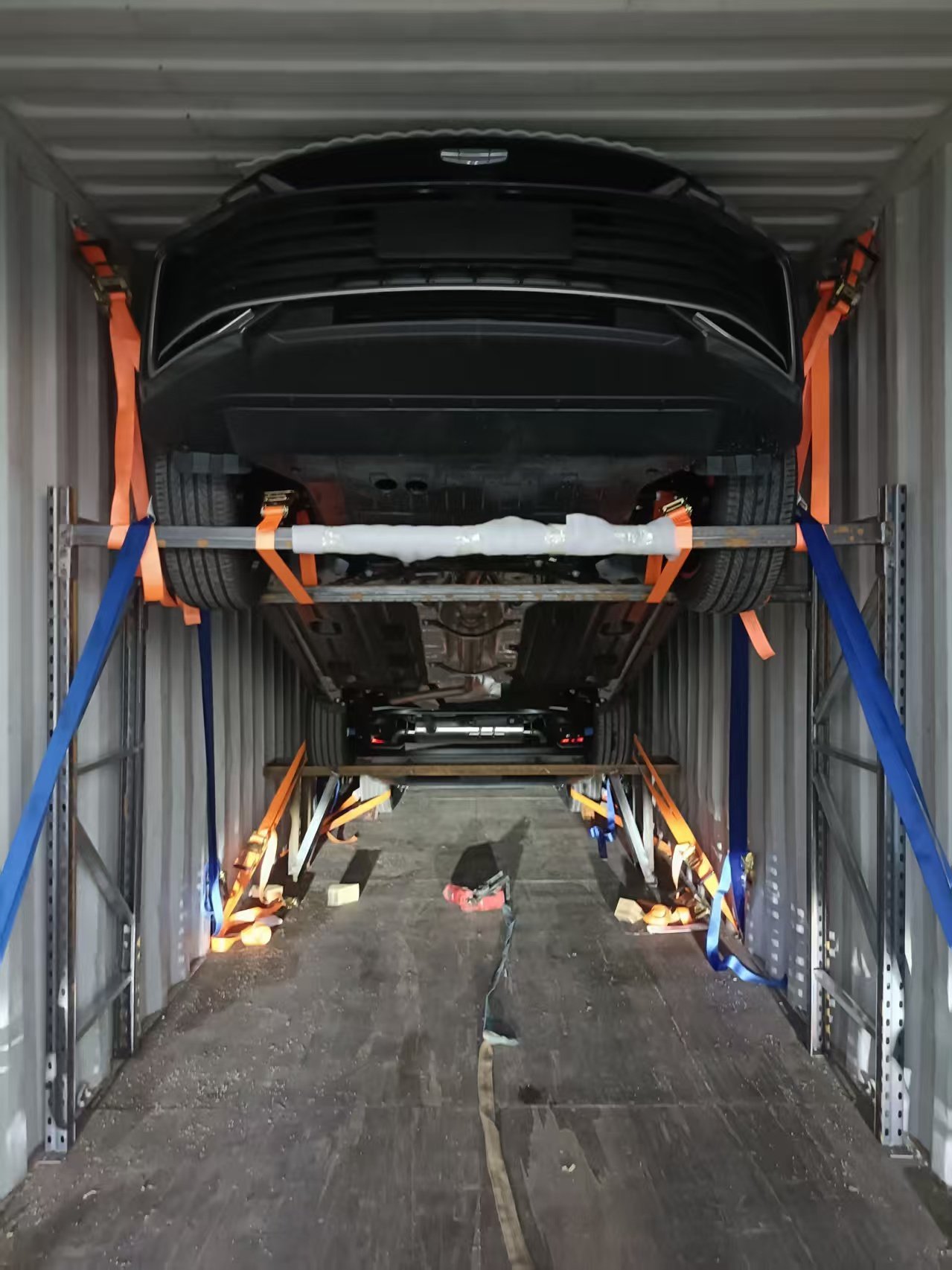 Under view of container racking system holding two vehicles